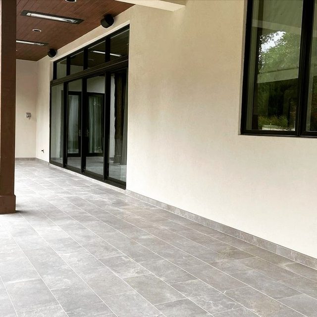 After: covered patio in large-format gray porcelain tile
