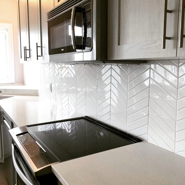 Tile backsplash: white chevron-pattern tile