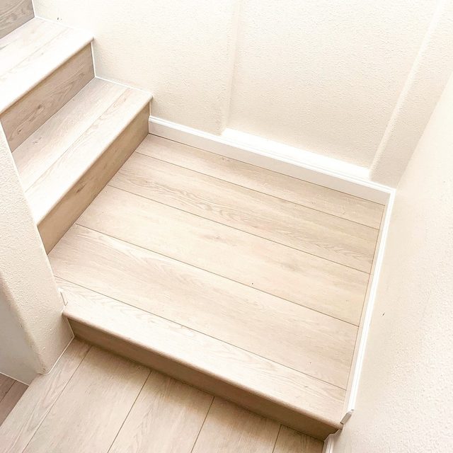 Stair landing in light vinyl plank with clean nosing